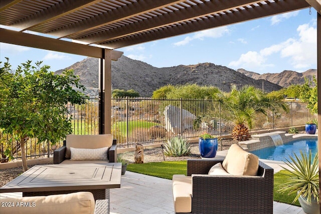 view of patio / terrace featuring a pergola, a mountain view, a fenced in pool, and pool water feature