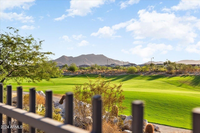 view of property's community with a mountain view and a yard