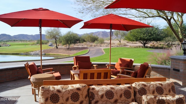 view of patio with a water and mountain view