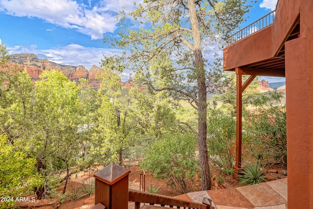 view of yard with a mountain view and a balcony