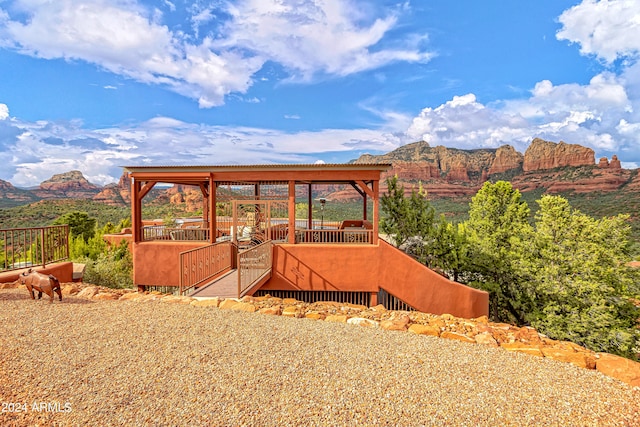 view of yard featuring a deck with mountain view and a gazebo