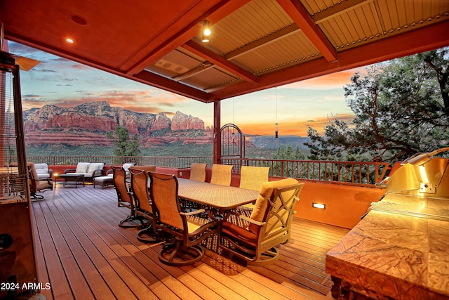 deck at dusk featuring outdoor lounge area and a mountain view