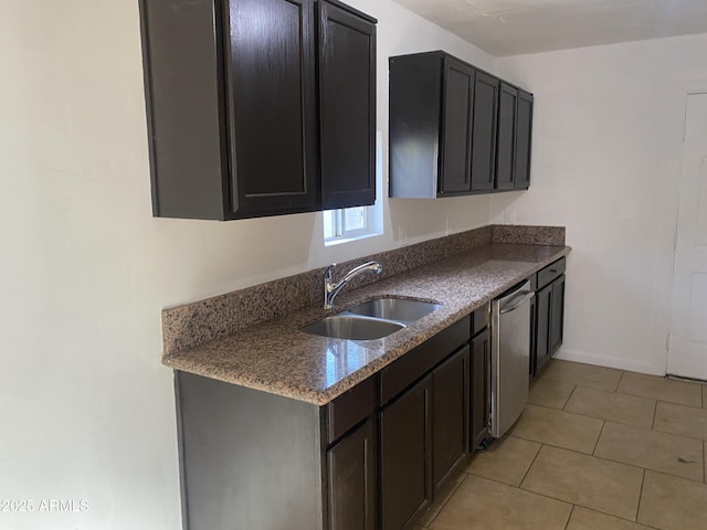 kitchen with a sink, stainless steel dishwasher, and light tile patterned flooring