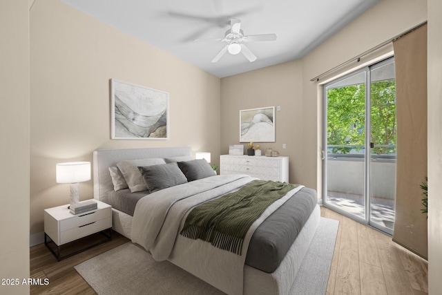 bedroom with access to outside, a ceiling fan, and wood finished floors