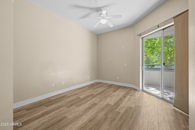 unfurnished room with a ceiling fan, baseboards, and light wood-style flooring