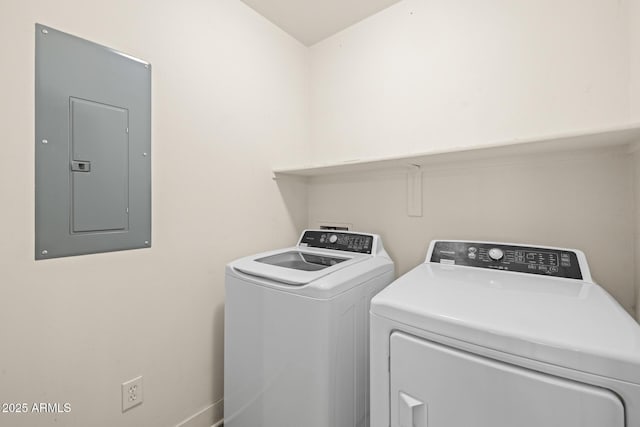 laundry room featuring washing machine and clothes dryer, laundry area, and electric panel
