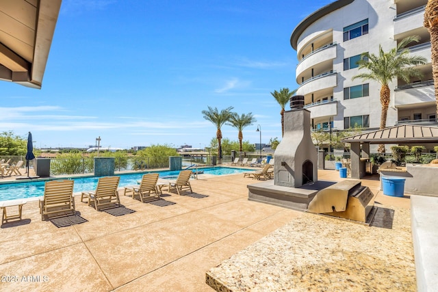 community pool with a gazebo, a patio area, and fence