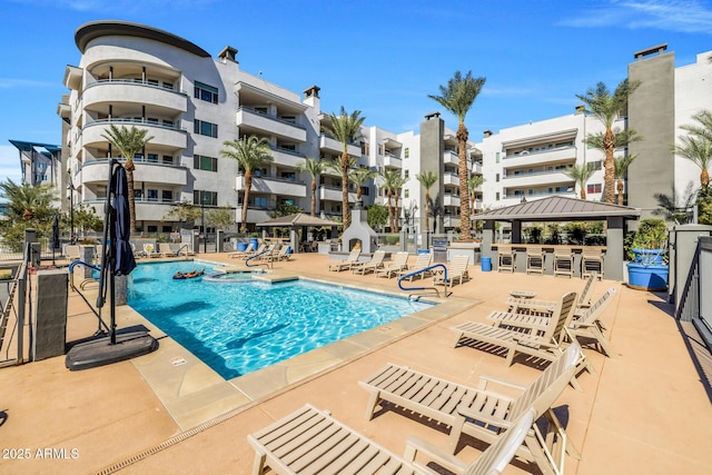 community pool featuring a patio and a gazebo