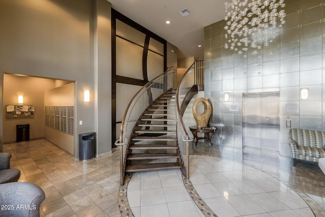 staircase featuring tile patterned floors, elevator, recessed lighting, a towering ceiling, and visible vents