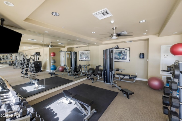 workout area with visible vents, recessed lighting, baseboards, and a tray ceiling