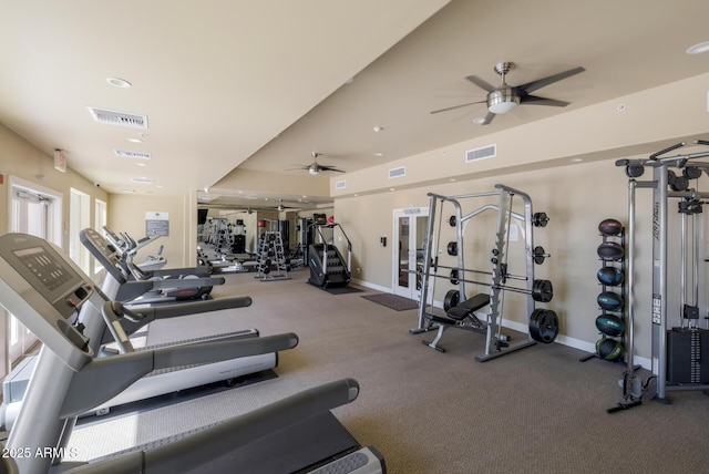 gym with baseboards, a ceiling fan, and visible vents
