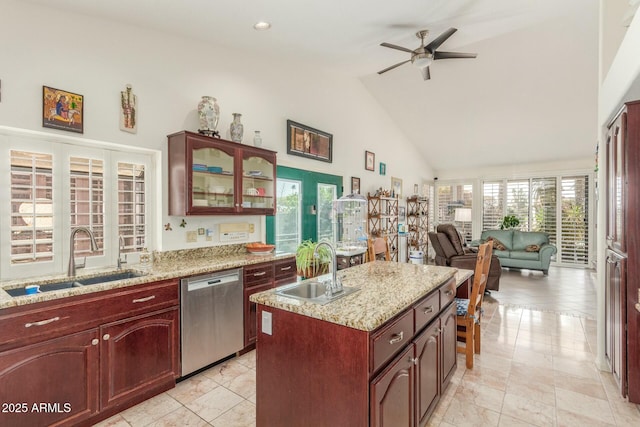 kitchen featuring a sink, a kitchen island, glass insert cabinets, and stainless steel dishwasher