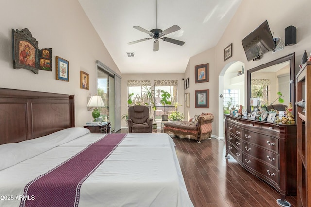 bedroom with access to exterior, arched walkways, dark wood-type flooring, a ceiling fan, and high vaulted ceiling