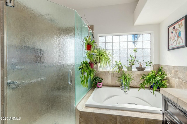 full bathroom with a bath, a stall shower, and vanity