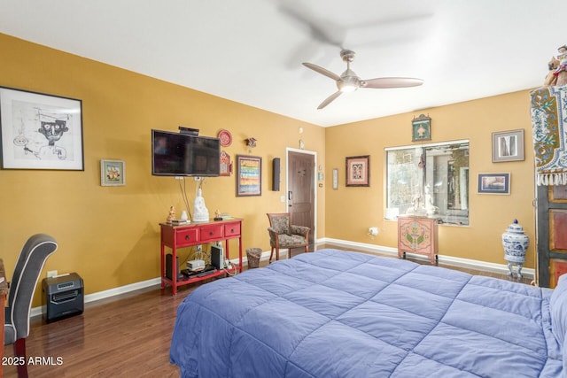 bedroom with ceiling fan, baseboards, and wood finished floors