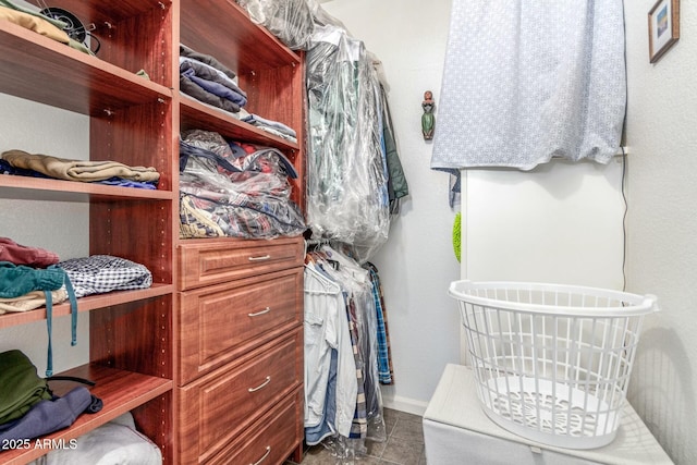 walk in closet featuring tile patterned flooring