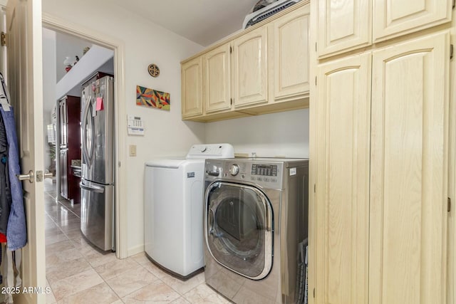 laundry room with cabinet space, separate washer and dryer, and light tile patterned flooring