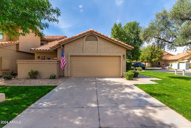 view of front of home with a garage and a front lawn