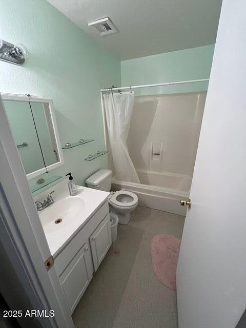 full bathroom featuring vanity, shower / tub combo, and toilet