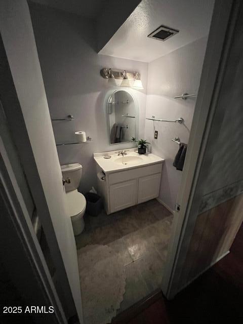 bathroom featuring vanity and toilet