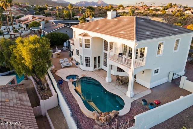 exterior space with a mountain view, a patio area, and a balcony