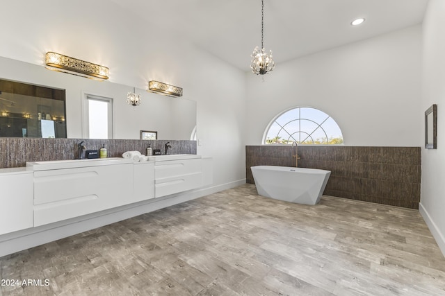 bathroom with a bathing tub, vanity, and hardwood / wood-style flooring