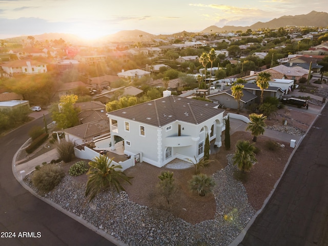 aerial view at dusk featuring a mountain view