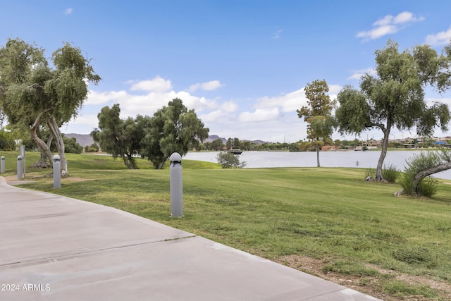 view of home's community featuring a yard and a water view