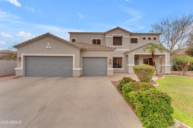 mediterranean / spanish home with stucco siding, concrete driveway, a front yard, a garage, and a tiled roof