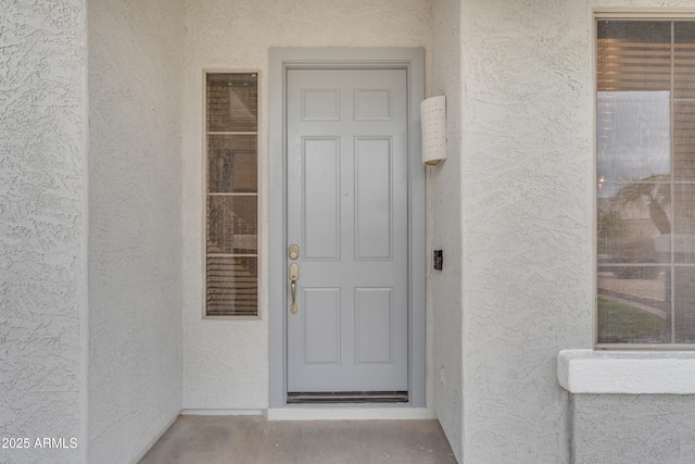 property entrance featuring stucco siding