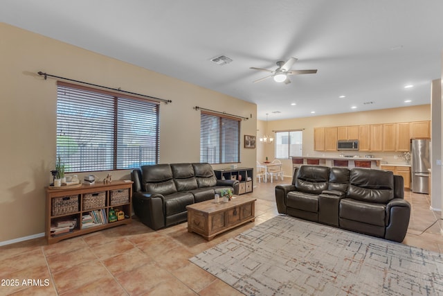 living room featuring visible vents, recessed lighting, light tile patterned floors, baseboards, and ceiling fan