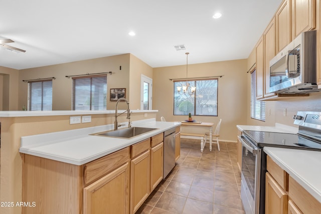 kitchen with light brown cabinets, visible vents, a sink, appliances with stainless steel finishes, and a chandelier