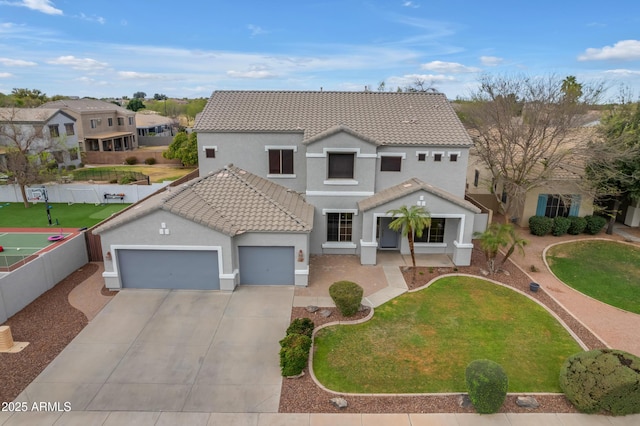 view of front facade with a front lawn, fence, concrete driveway, a garage, and a tiled roof