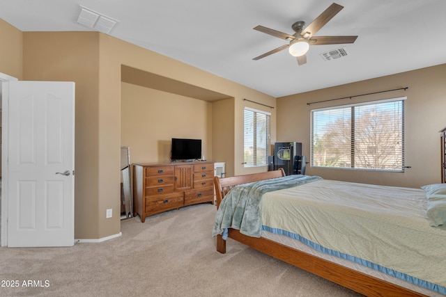 bedroom featuring visible vents, carpet floors, and a ceiling fan