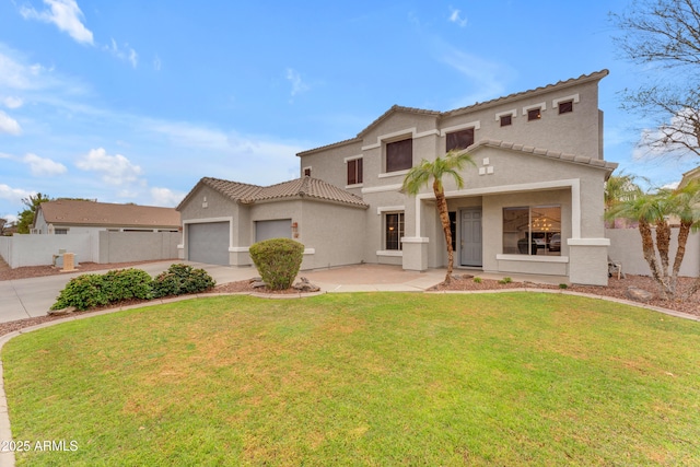 mediterranean / spanish home featuring fence, concrete driveway, a front yard, stucco siding, and an attached garage