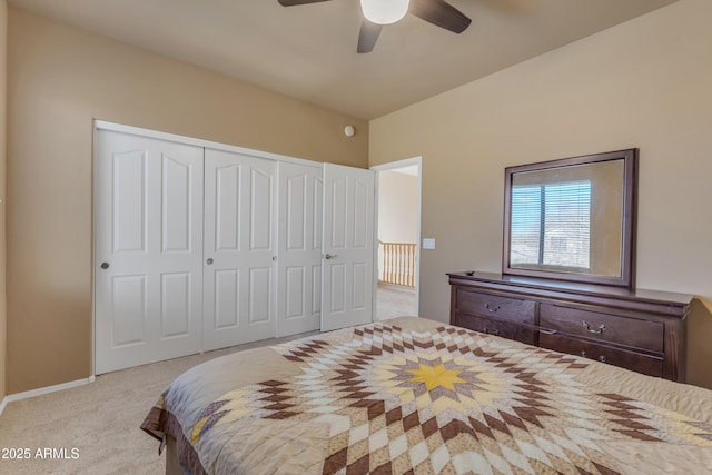 bedroom with a ceiling fan, carpet, a closet, and baseboards