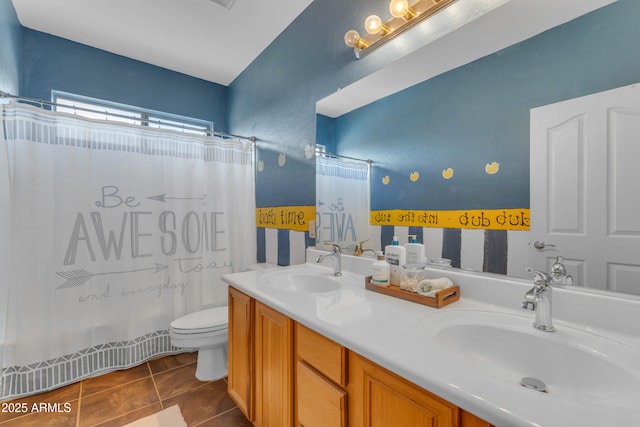 bathroom with tile patterned floors, curtained shower, toilet, and a sink