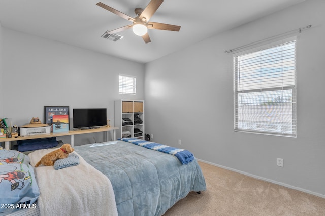 carpeted bedroom with visible vents, ceiling fan, and baseboards