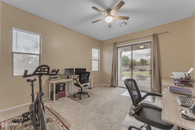 home office featuring carpet flooring, visible vents, baseboards, and ceiling fan