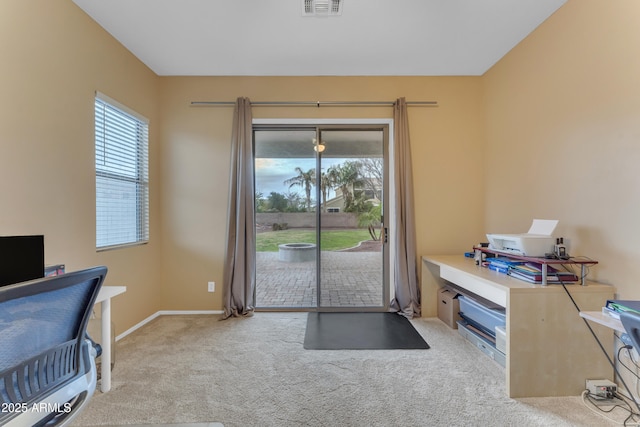 office area with a wealth of natural light, carpet flooring, baseboards, and visible vents