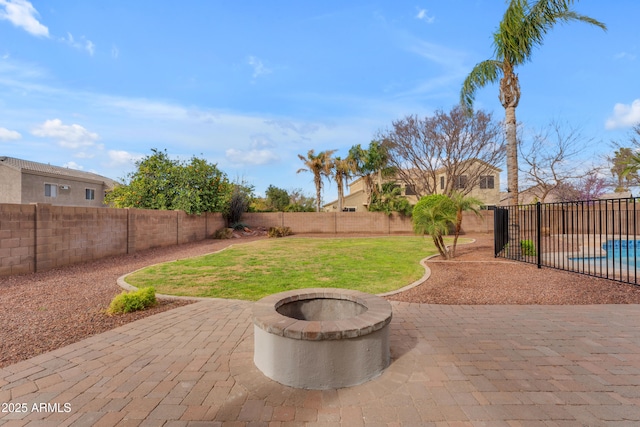 view of patio with a fenced backyard and an outdoor fire pit