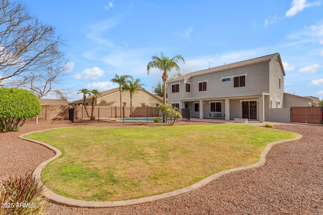 back of house featuring a patio, a fenced backyard, a fenced in pool, and stucco siding