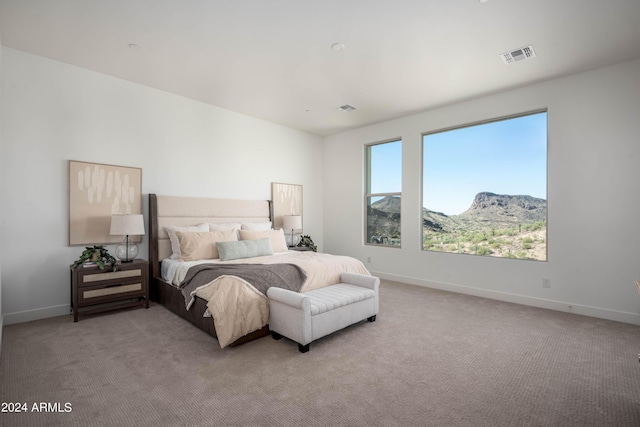 carpeted bedroom with a mountain view