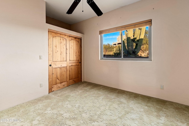 unfurnished bedroom with ceiling fan, a closet, and light colored carpet