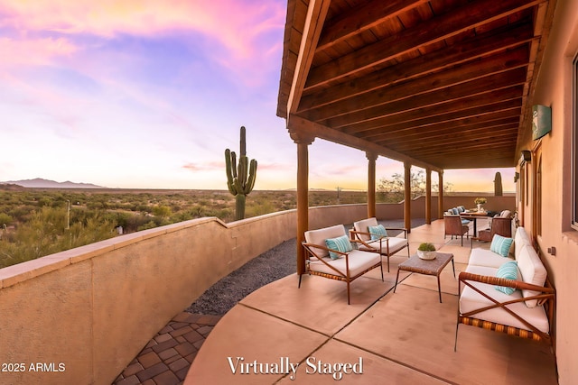 patio terrace at dusk featuring an outdoor living space