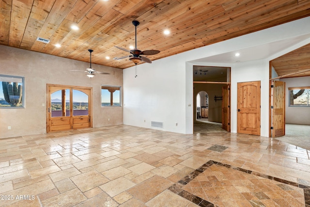 spare room with ceiling fan, wooden ceiling, and a high ceiling