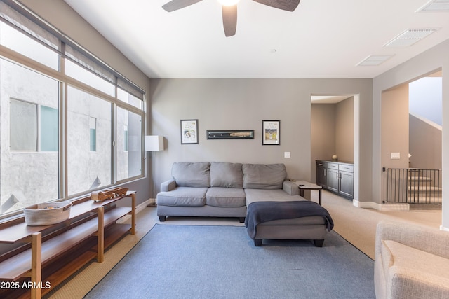 living room with ceiling fan and carpet floors