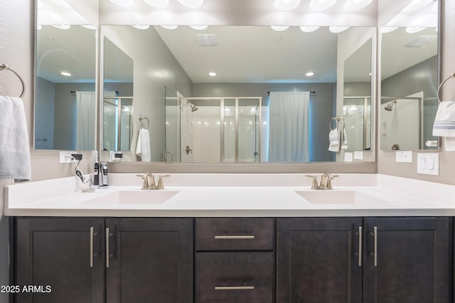 bathroom with vanity and a shower with door