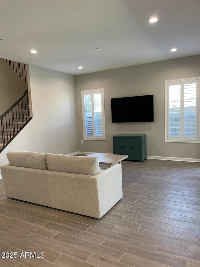 living area with visible vents, baseboards, wood tiled floor, stairs, and recessed lighting