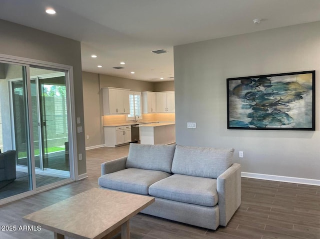 living room featuring recessed lighting, wood finished floors, and baseboards